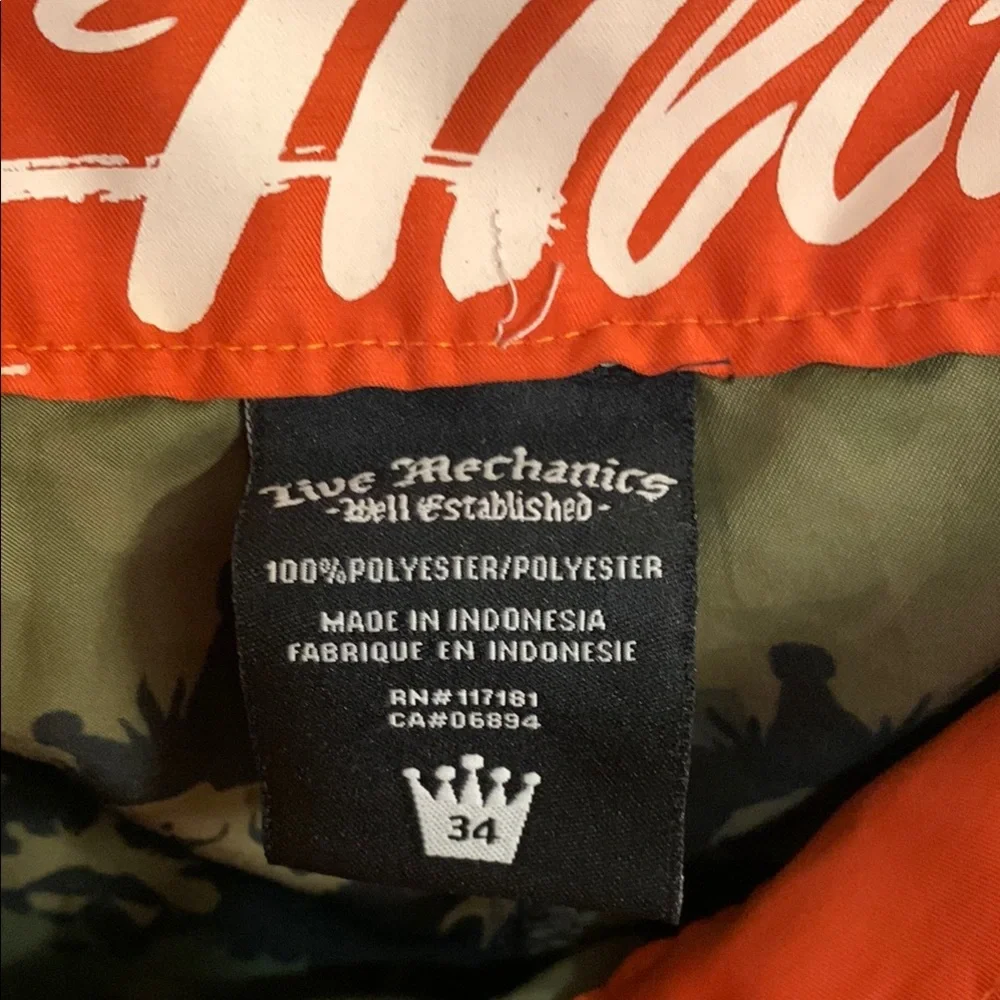 Live Mechanics Green/Blue Board Shorts with Drawstring Waist Camo Lion design.